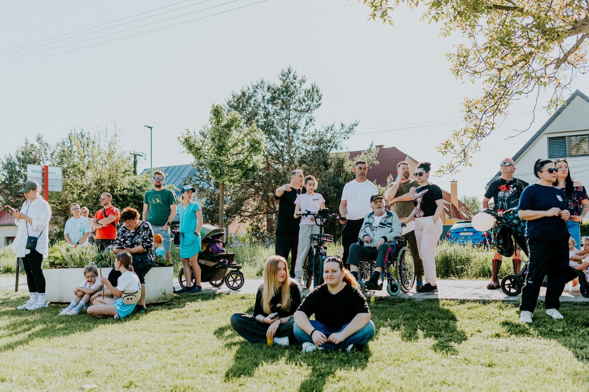 A diverse group enjoying a sunny day outdoors, showcasing community and togetherness.